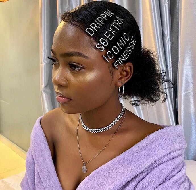 Slogan hair clips on a girl with natural hair bun