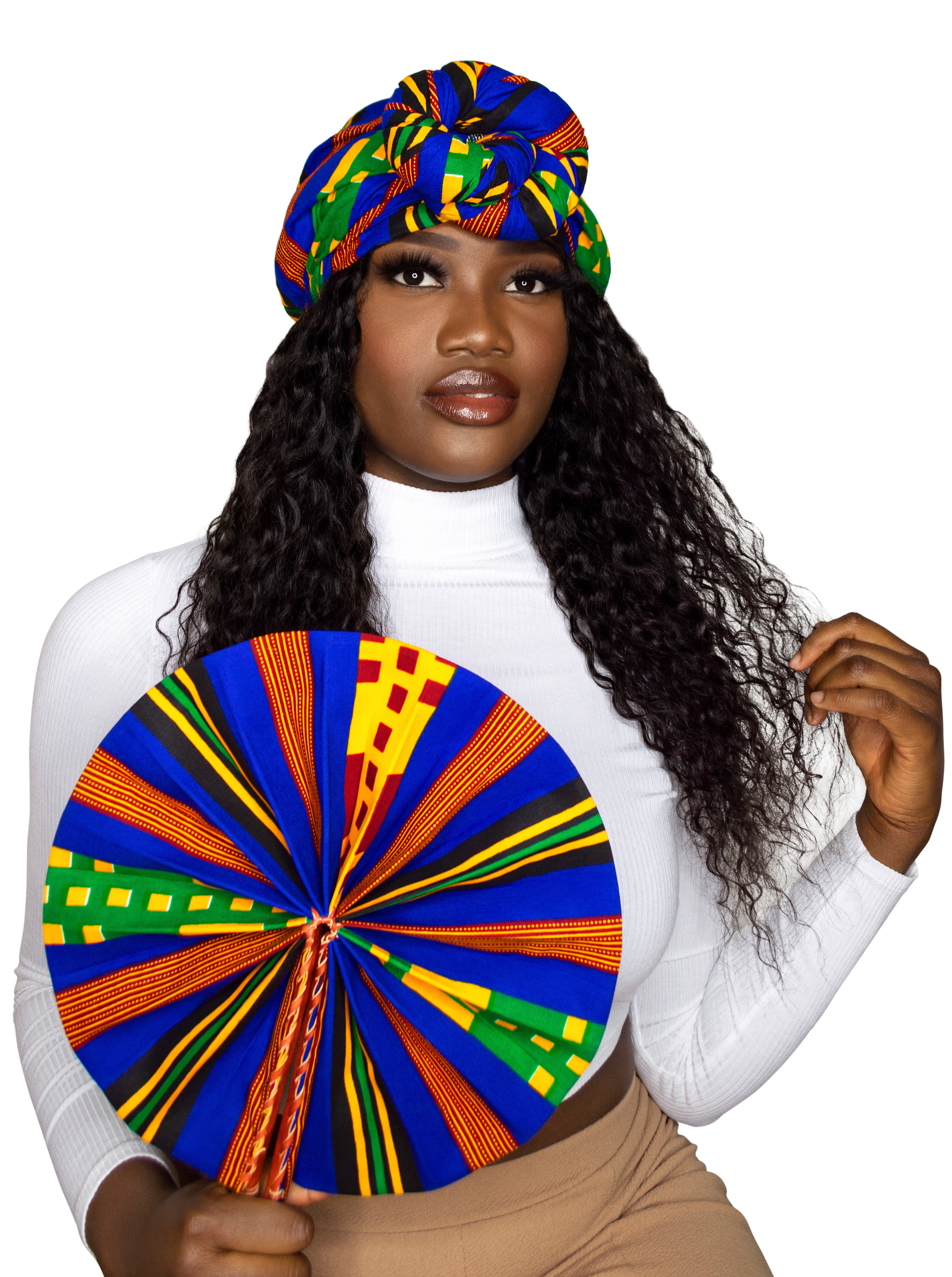 A woman with kente ankara headwrap and hand fan