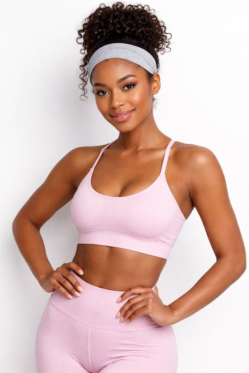 a woman wearing tape-ins and work out gear