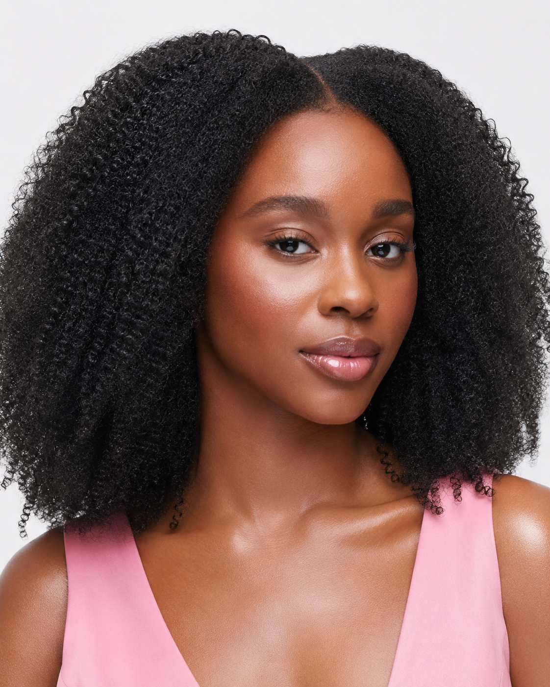 A woman wearing hair a kinky coarse 4c wig that 