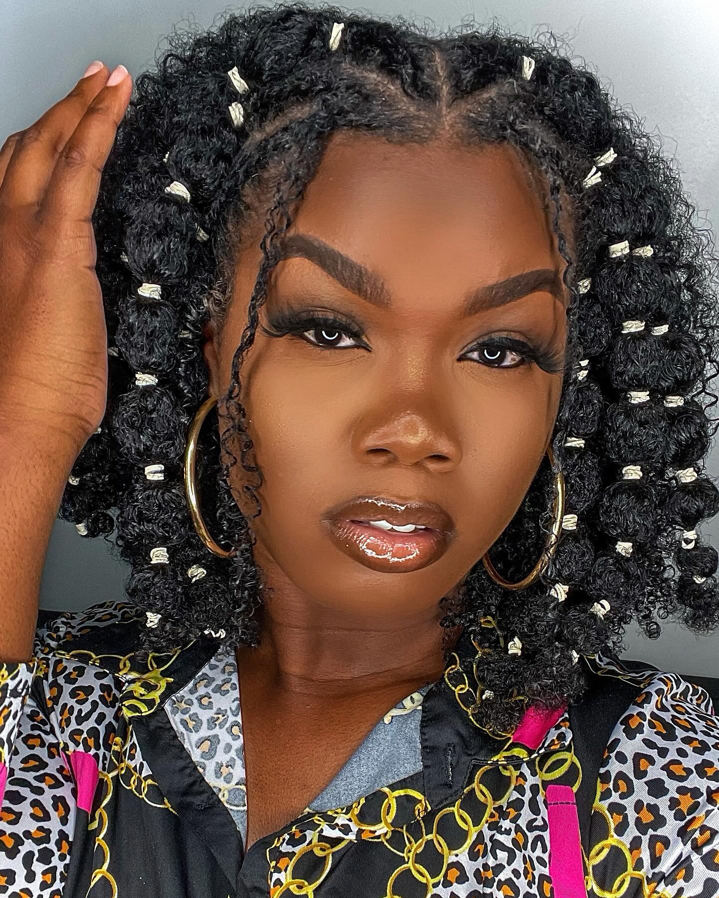 a black woman with bubble braids 