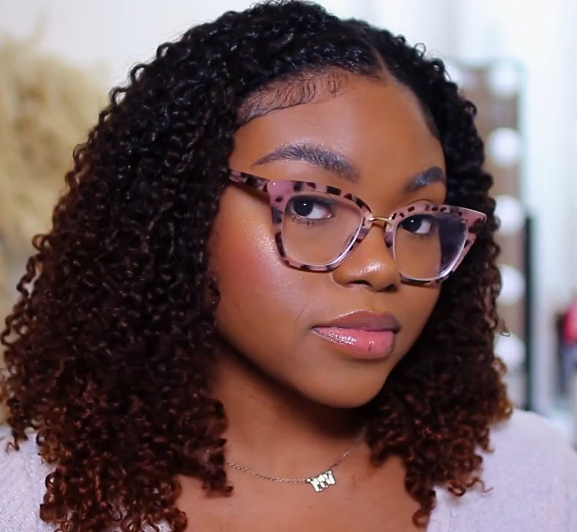 a woman wearing curly tape-in extensions