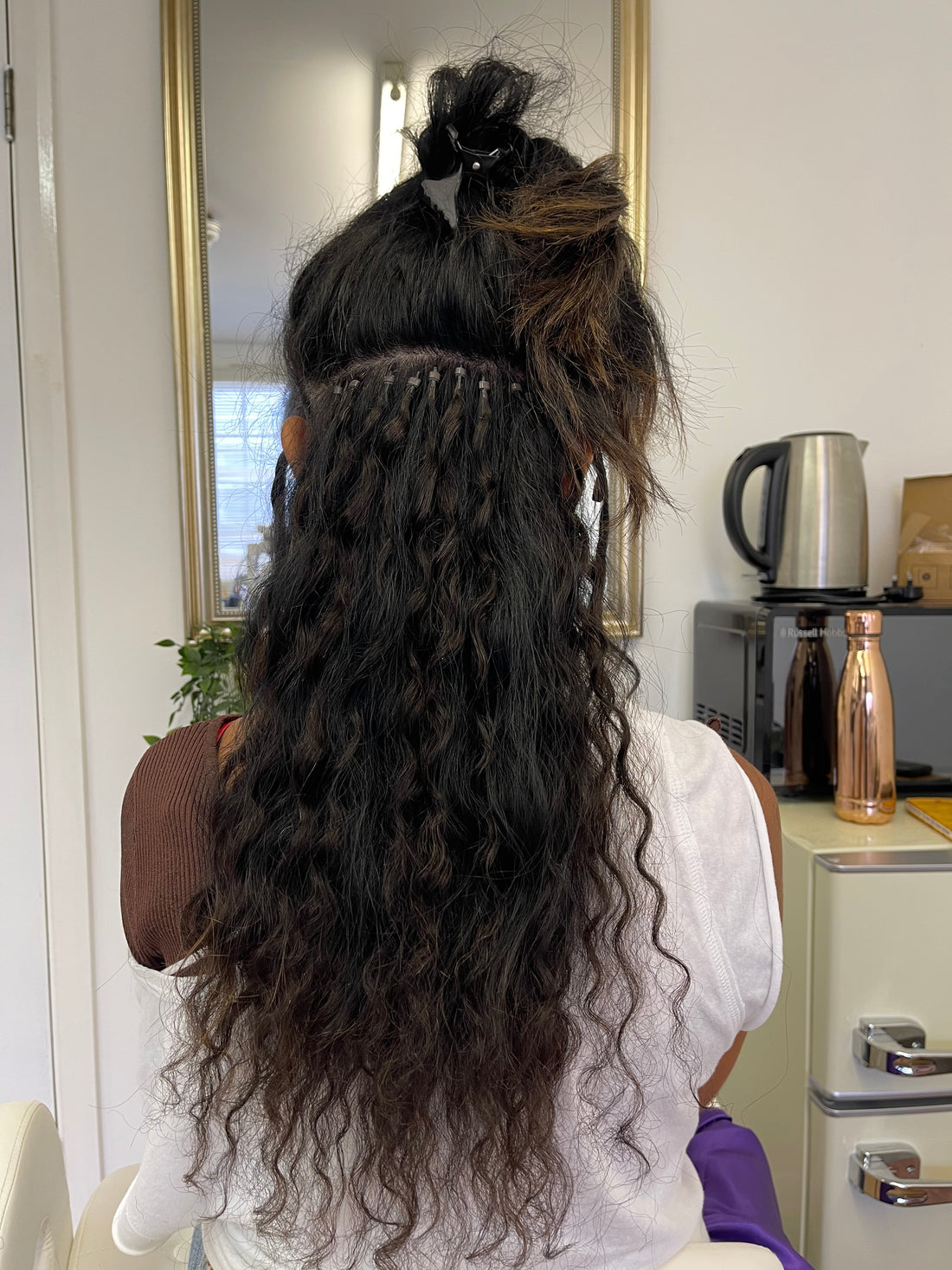 A woman with microlinks in a salon in the UK