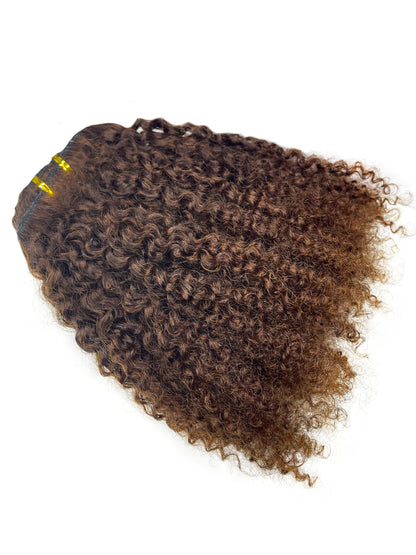 Brown curly weft that has been colored by a professional 