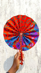 Kente ankara hand fan on a woman's hand